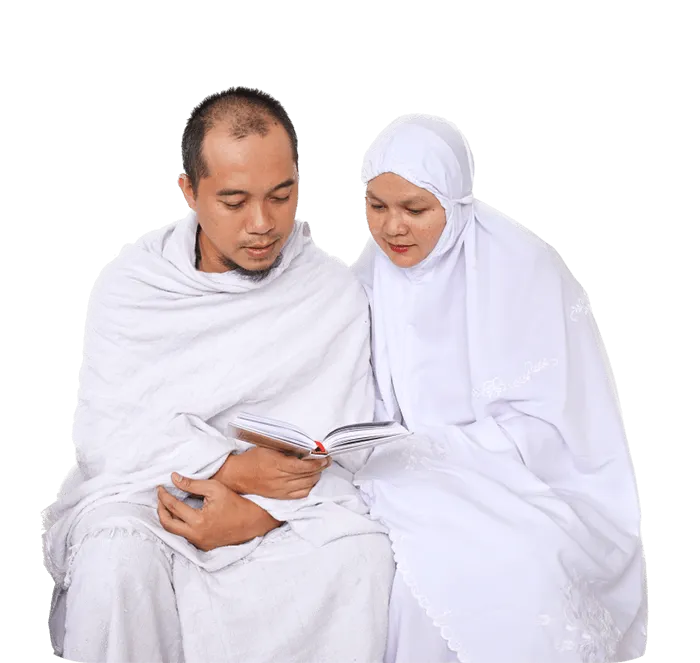 Muslim hajj couple in white clothes praying with Al Quran together